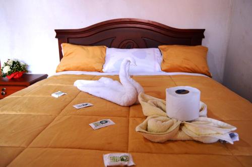 a bed with toilet paper and towels on it at Quilotoa Green Lake in Quilotoa