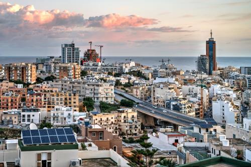 a city with buildings and a highway and a bridge at Escape to St Julians in St Julian's