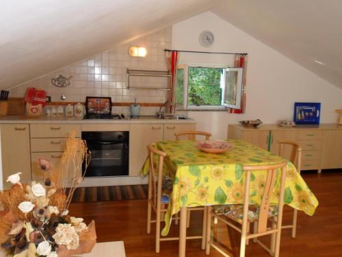 a kitchen with a table with a yellow table cloth at MANSARDA PARADISO GOLFO DI PORTOFINO in Sestri Levante