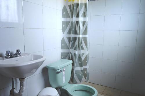 a bathroom with a toilet and a sink at Quilotoa Green Lake in Quilotoa