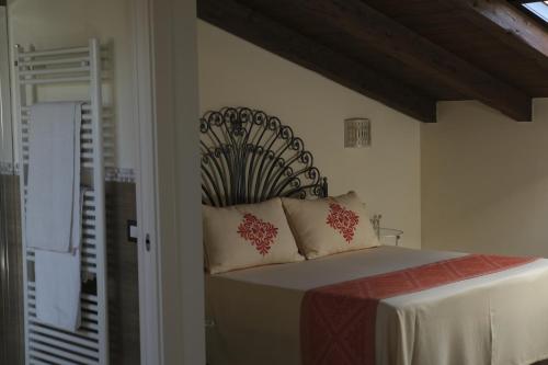 a bedroom with a bed with a iron head board at Inghirios Wellness Country Resort in Santa Maria la Palma