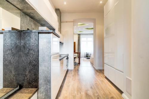 a kitchen with a glass door leading to a living room at Diamond Residence - Marble Apartment in Budapest