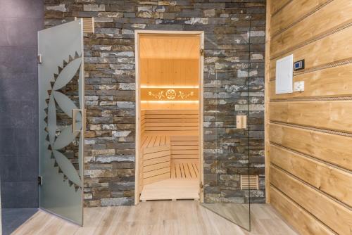 an empty sauna in a room with a brick wall at Apartamenty Augustynówka in Brzegi