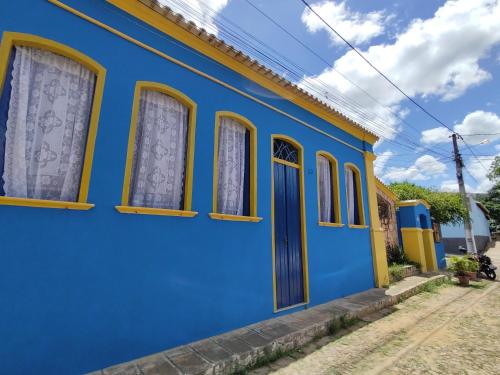 a blue building with windows and a blue door at Pousada Solar Azul in Lençóis
