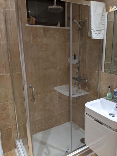 a bathroom with a shower and a sink at Creek View in Wootton Bridge