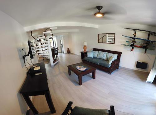 a living room with a couch and a table at Nanny Estates Cabarete kiters Condo C-6 in Cabarete