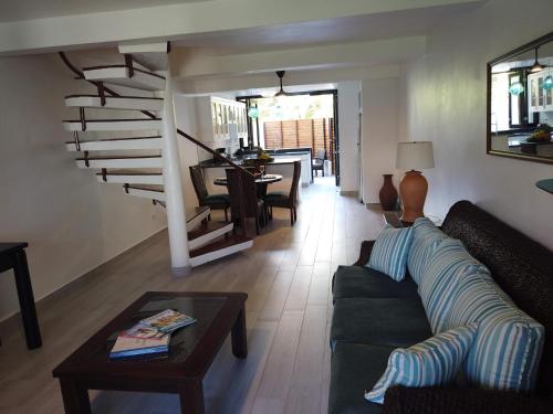 a living room with a couch and a table at Nanny Estates Cabarete kiters Condo C-6 in Cabarete