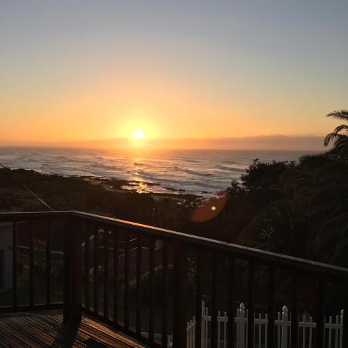 a sunset over the ocean from a balcony at Shad in Palm Beach