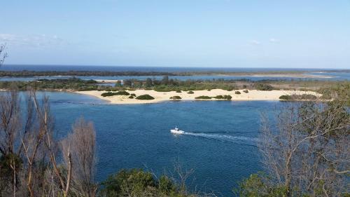 a boat in a large body of water at Abalone Guest Accommodation in Lakes Entrance