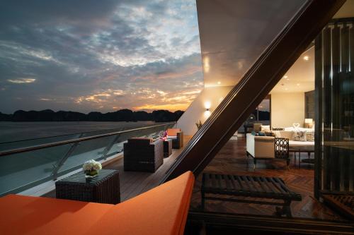 a balcony of a building with a sunset in the background at Stellar of the Seas Cruise in Ha Long