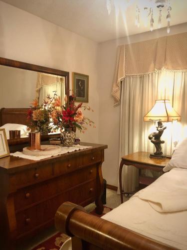 a bedroom with a bed and a table with a lamp at WINNIE'S BED & BREAKFAST in Lawrenceburg