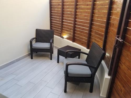 three chairs sitting in a room with a window at Nanny Estates Cabarete kiters Condo C-6 in Cabarete