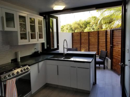 a kitchen with a sink and a counter top at Nanny Estates Cabarete kiters Condo C-6 in Cabarete