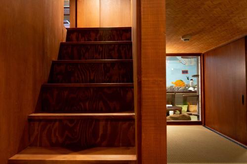 a stairwell in a room with a door and a room with aumbledore at Cat Spa & Cat Ryokan by Neco Republic Osaka in Osaka
