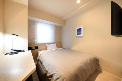 Una televisión o centro de entretenimiento en S-peria Inn Nihombashi Hakozaki