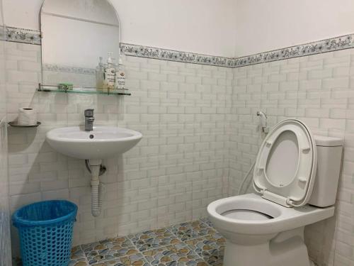 a bathroom with a toilet and a sink at Làng biển Homestay in Quảng Ngãi