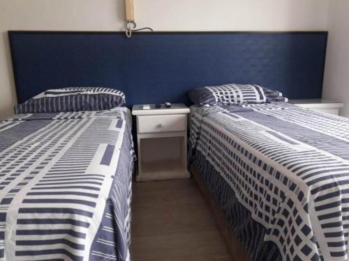 two beds sitting next to each other in a bedroom at Uni Medicina in Rosario