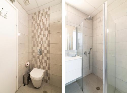 a bathroom with a toilet and a shower at Hilton Bay Apartment with Bedroom shelter in Tel Aviv