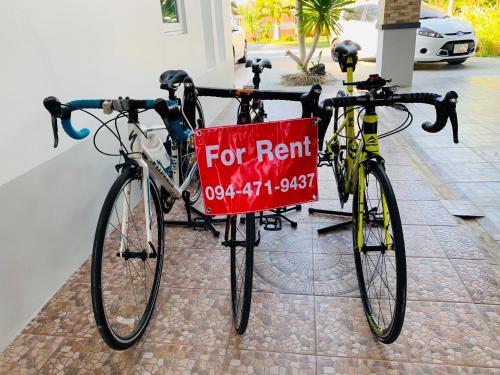 two bikes parked next to each other with a red sign on them at ศรีสุภาวดีรีสอร์ท-Srisupawadee resort in Prachuap Khiri Khan