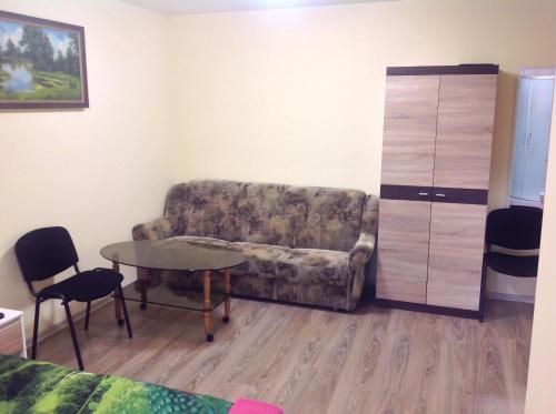 a living room with a couch and a table at Globepark in Mažonai