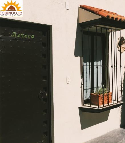 a door to a building with a cage with a plant in it at Posada Equinoccio in Bernal