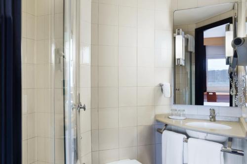 a bathroom with a toilet and a sink and a mirror at ibis Amman in Amman