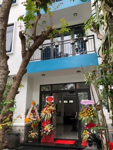 a building with flowers in front of it at Quynh Long Villa in Hoi An