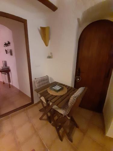 a wooden table and a chair in a room at Cuevas Galera - Cuevas de la Luz in Galera