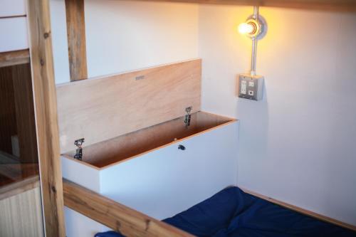 a room with a wooden shelf on the wall at chAho Hostel Nirasaki / Outdoor Base in Nirasaki