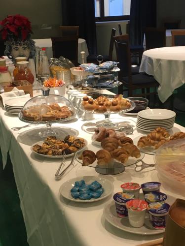 a table with plates of food on a table at Panorama Hotel in Siracusa