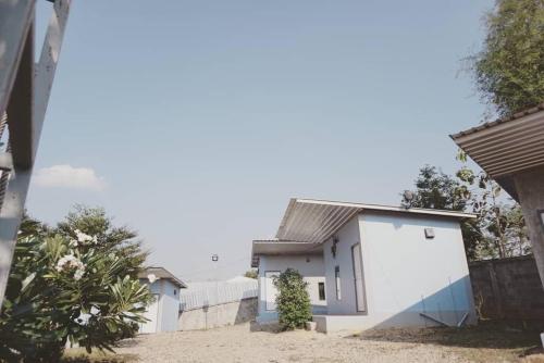 a house with white walls and a fence at Chill loft โฮมเสตย์ in Nan