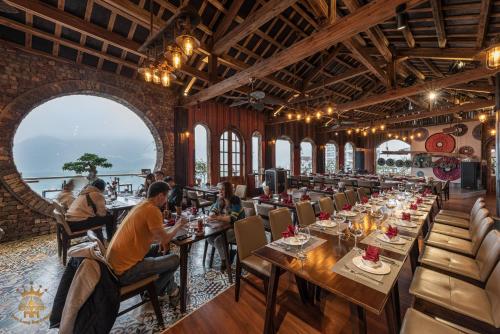 a dining room with people sitting at tables at Chau Long Sapa 2 Hotel in Sa Pa