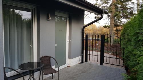 a patio with a table and chairs and a fence at Hotel Amerika in Havířov