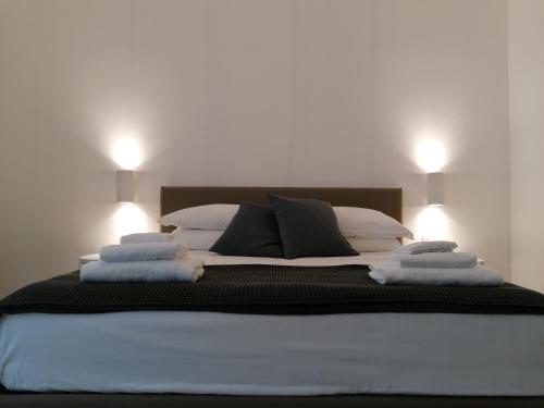 a large bed with two lights on top of it at Chiaralice in Noto