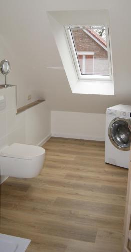 a bathroom with a sink and a washing machine at Friedeburga in Friedeburg