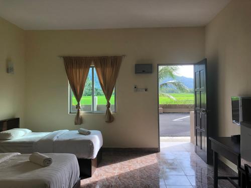 Postel nebo postele na pokoji v ubytování DVilla Guesthouse Langkawi