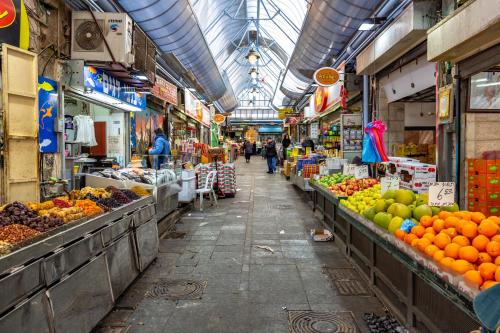 a market with fruits and vegetables and people walking through it at ibis Jerusalem city Center - An AccorHotels Brand in Jerusalem