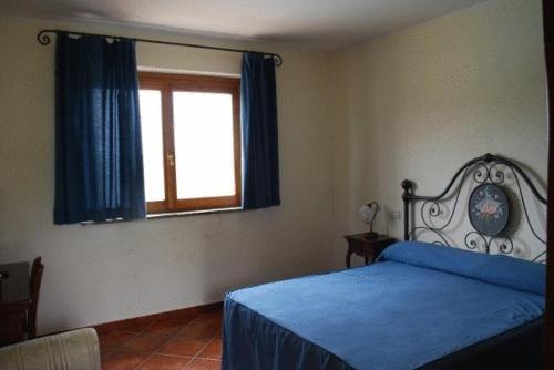 Кровать или кровати в номере Le Murelle Country Resort