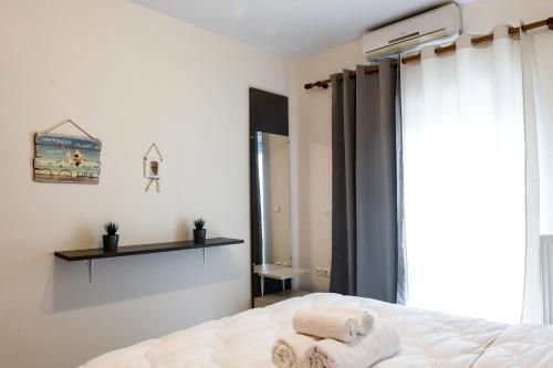 a bedroom with a bed with towels on it at Papi's Free Parking Apartments 2 - 2 Bedroom in Alexandroupoli
