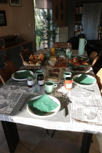 a table with plates of food on it at Gesves Côté Jardin in Gesves