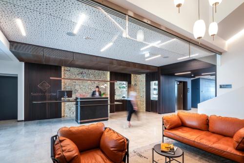 a lobby with two leather couches and a counter at Sainte-Barbe Hôtel & Spa Le Conquet - MGallery in Le Conquet