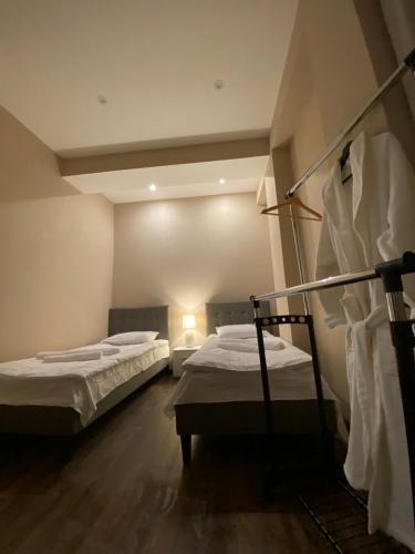 a room with two beds in a room at APARTMENT SIXTEEN in Tbilisi City