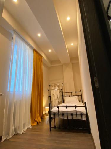 a bedroom with a bed and a window at APARTMENT SIXTEEN in Tbilisi City