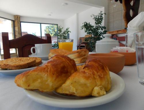 a plate of bread and croissants on a table at Portal De Los Valles in Chicoana
