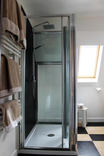 a shower with a glass door in a bathroom at B&B Milu' in Crotone