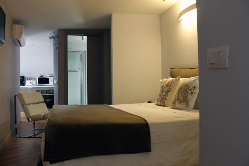 a hotel room with a bed and a chair at B&B Milu' in Crotone