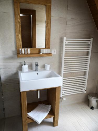 a bathroom with a white sink and a mirror at STONEGALLERY in Ždiar