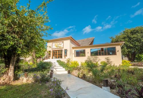 a home with a pathway leading to the front of the house at Kiwengwa Beach Resort in Kiwengwa