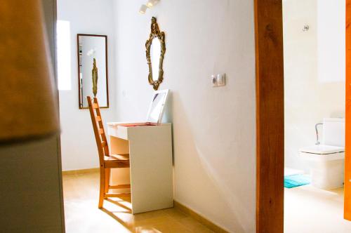 a room with a chair and a laptop on a desk at Casa Tigot in Puerto del Carmen