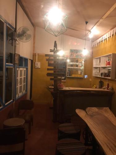 a restaurant with a bar with a table and chairs at Sook Jai Guest House in Chiang Rai